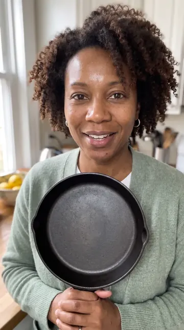 Dana holding a cast-iron pan