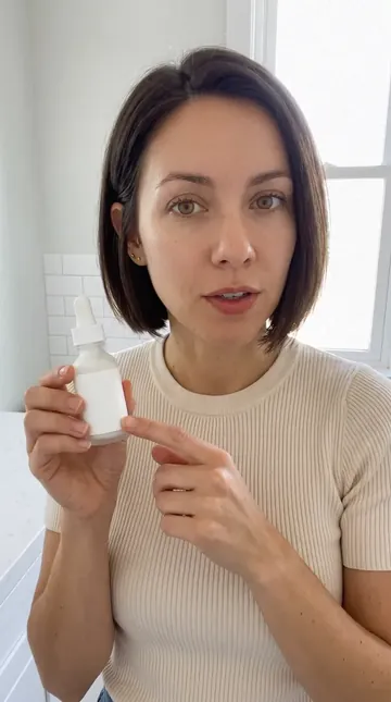 Nora holding a serum bottle